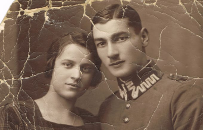 Old cracked and damaged photograph before AI restoration